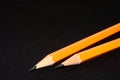 Two yellow Pencils on dark black blurred background. stationery. Office tool. Business concept. Royalty Free Stock Photo