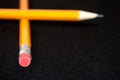 Two yellow Pencils on dark black blurred background. stationery. Office tool. Business concept. Royalty Free Stock Photo