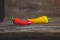 Two Yellow and Red Vegetable Peppers on Wood Background Royalty Free Stock Photo