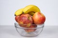 Two Bananas And Four Apples in Glass Bowl Isolated Composition on White Background Royalty Free Stock Photo