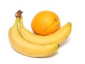 Two yellow ripe bananas and orange Royalty Free Stock Photo