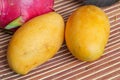 Two yellow ripe mangoes and a dragon fruit Royalty Free Stock Photo