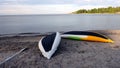 Two yellow, white and green canoes placed upside down on the beach to dry after a row Royalty Free Stock Photo