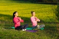 Yoga Girls on the background field of yellow flowers. Royalty Free Stock Photo