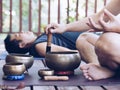 Two yoga men do yoga outdoor with singing bowls Royalty Free Stock Photo