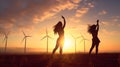 Two youn woman practicing joga in beaufitul sunset light wth windfarm in the background. Relaxed, calm lifestyle