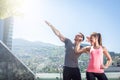 Two young adult fitness models posing on rooftop. Royalty Free Stock Photo