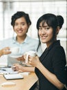 Two young adults smiling with coffee