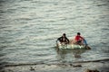 Two young adults were enjoy boating on the river.