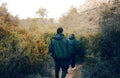 two young adventurers walking through a lush green forest, very warm and having fun Royalty Free Stock Photo