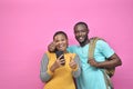 two young african friends, boy and girl, looking excited while viewing something on their smartphone Royalty Free Stock Photo