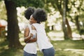 Two young afro-american sisters hugging in a park Royalty Free Stock Photo