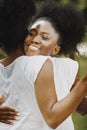 Two young afro-american sisters hugging in a park Royalty Free Stock Photo