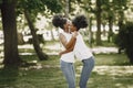 Two young afro-american sisters hugging in a park Royalty Free Stock Photo
