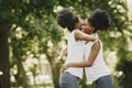 Two young afro-american sisters hugging in a park Royalty Free Stock Photo