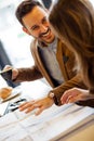 Two young architects discussing building plans during a meeting in a modern cafe Royalty Free Stock Photo