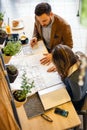 Two young architects looking over building plans during a meeting Royalty Free Stock Photo