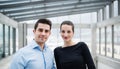 Two young architects standing in office, looking at camera. Royalty Free Stock Photo