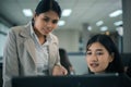 Two young asia business woman working together in office space Royalty Free Stock Photo