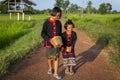 Two young Asian girls dressed according to local traditions are walking, chatting happily and smiling on the road Royalty Free Stock Photo