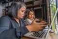 Two young Asian woman freelancers working on laptop