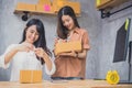 Two young Asian people startup small business entrepreneur SME distribution warehouse with parcel mail box. small business owner h Royalty Free Stock Photo