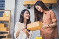 Two young Asian people startup small business entrepreneur SME distribution warehouse with parcel mail box. small  owner home Royalty Free Stock Photo