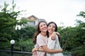 Two young Asian woman hugging in the balcony