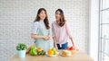 Two young asian women healthy food bloggers look at camera while recording video with happy moment, vlog concept, people and