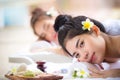 Two young Asian women relaxing in spa salon. Beauty service with friends on spa bed. Royalty Free Stock Photo