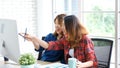 Two young asian women working with computer at home office with happy emotion, working at home, small business, office casual Royalty Free Stock Photo