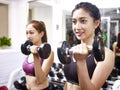 Young asian woman exercising working out in gym Royalty Free Stock Photo