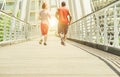 Two young athletes making jogging in a urban contest area outdoor - Runners training outdoor - Running for a sportive healthy