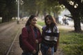 Two young Indian sisters walking in a field in winter afternoon. Royalty Free Stock Photo