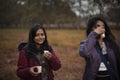 Two young Indian sisters walking in a field in winter afternoon. Royalty Free Stock Photo