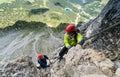 Two young attractive female mountain climber in the Dolomites of Italy with a great panorama view