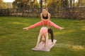 Two young attractive girls practicing yoga outdoor. Royalty Free Stock Photo