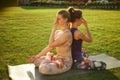 Two young attractive girls practicing yoga outdoor. Royalty Free Stock Photo