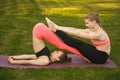 Two young attractive girls practicing yoga outdoor. Royalty Free Stock Photo