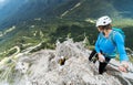 Two young attractive mountain climbers on very exposed Via Ferrata in the Dolomites of Italy