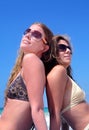 Two young attractive women chilling in the sun on holiday or vac