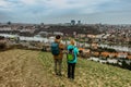 Two young backpackers enjoying view of Prague city skyline and Vltava river,Czech Republic.Attractive landscape with deep valley, Royalty Free Stock Photo