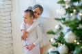 Two young ballet dancer hug near Christmas tree Royalty Free Stock Photo