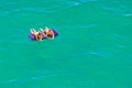 Two young beautiful Caucasian women in bikini sunbathing and relaxing lying on mattress in calm azure water of Black Sea Royalty Free Stock Photo