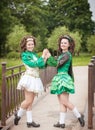 Two young beautiful girl in irish dance dress posing outdoor