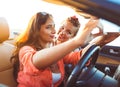 Two young beautiful girls are doing selfie in a convertible Royalty Free Stock Photo