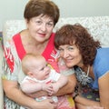 Two young beautiful grandmothers communicate with a small granddaughter.
