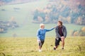 Two young beautiful runners in autumn nature, stretching legs Royalty Free Stock Photo