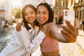 Two young beautiful smiling happy asian girls taking selfie Royalty Free Stock Photo