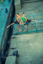 Two young beautiful twin sister dancing ballet in the city with ballet costume. urban sync dance. industrial street dancing. with Royalty Free Stock Photo